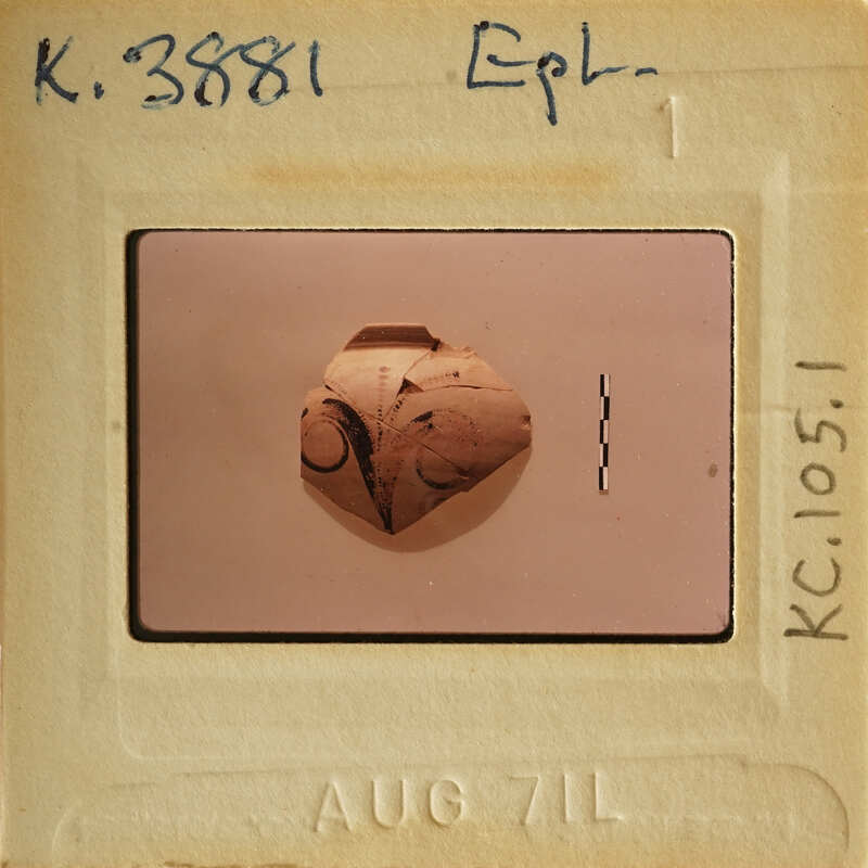 Ancient artifact with intricate designs, possibly pottery, photographed on an old slide.
