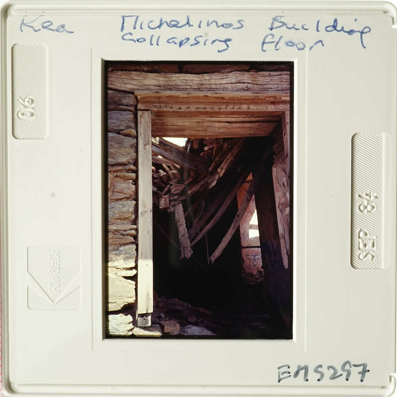 A photograph showing an old, weathered wooden structure with visible beams and stone elements.