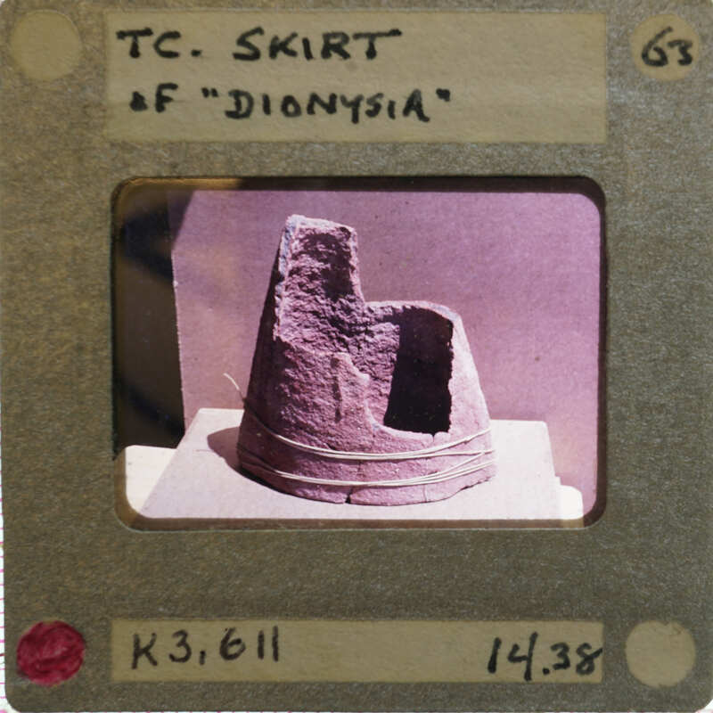 Fragments of terracotta skirt of figurine upright.