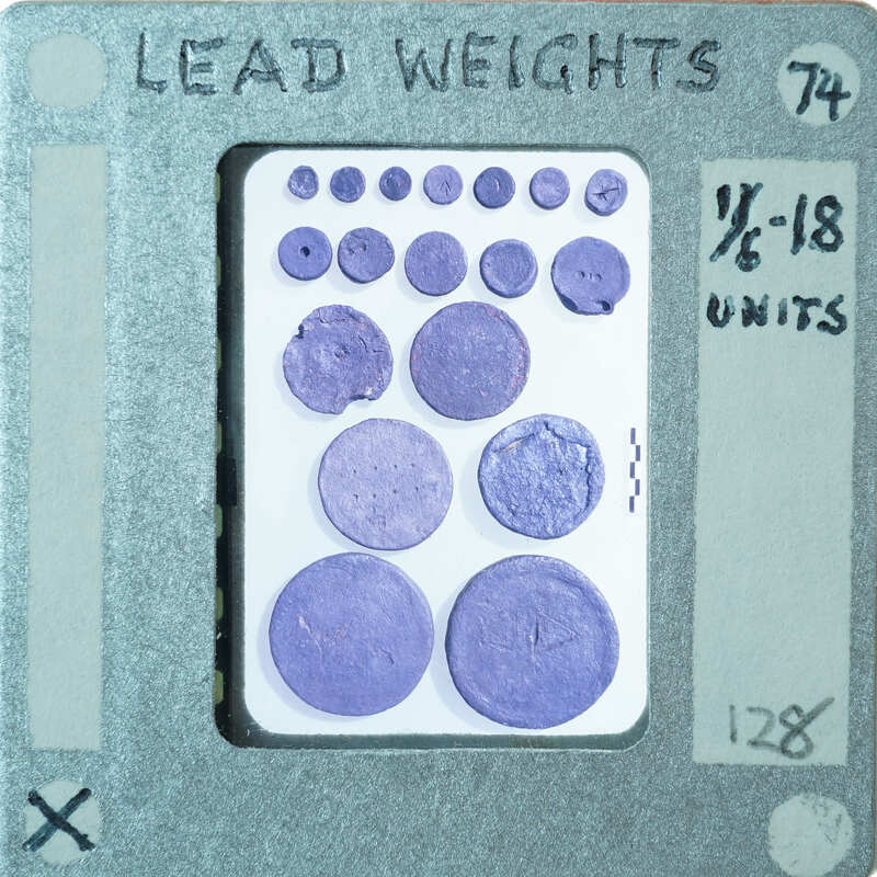 Collection of circular pieces of metal identified as lead weights.