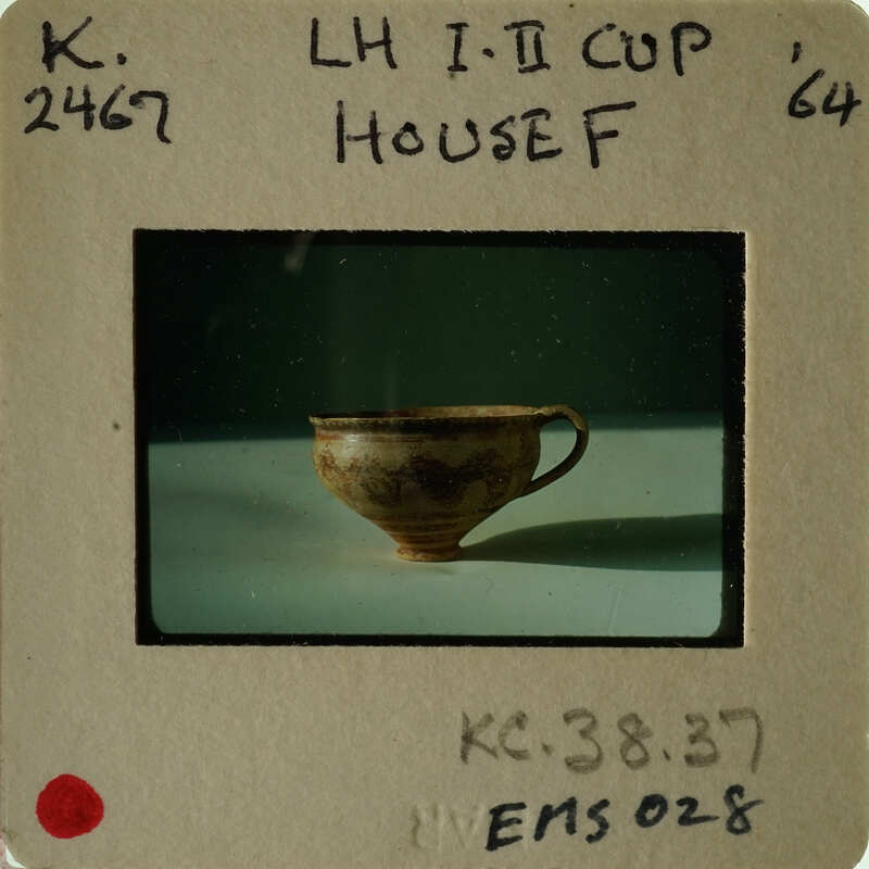 Old cup on table with vintage photo label.