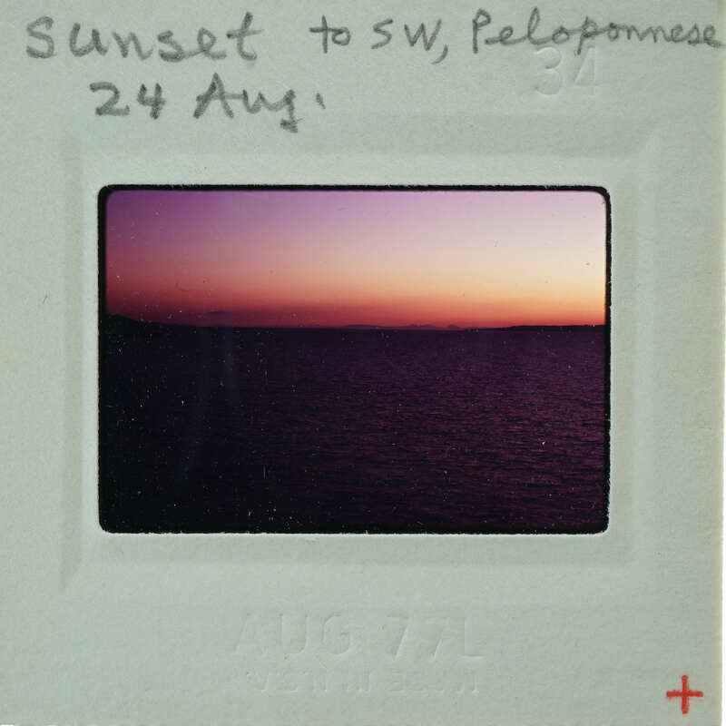 Photo of a sunset over water, with the image date and location written on it.