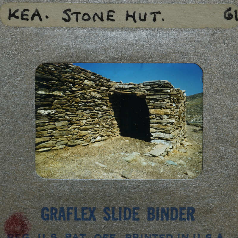 A photograph of a stone hut on a slide.