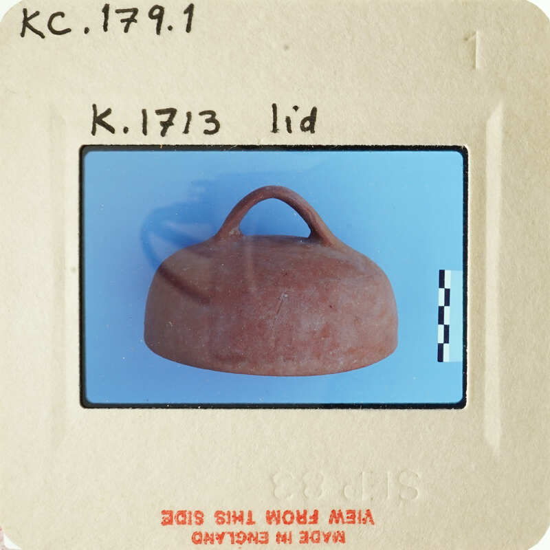 A small brown clay jug with handles on a blue background.
