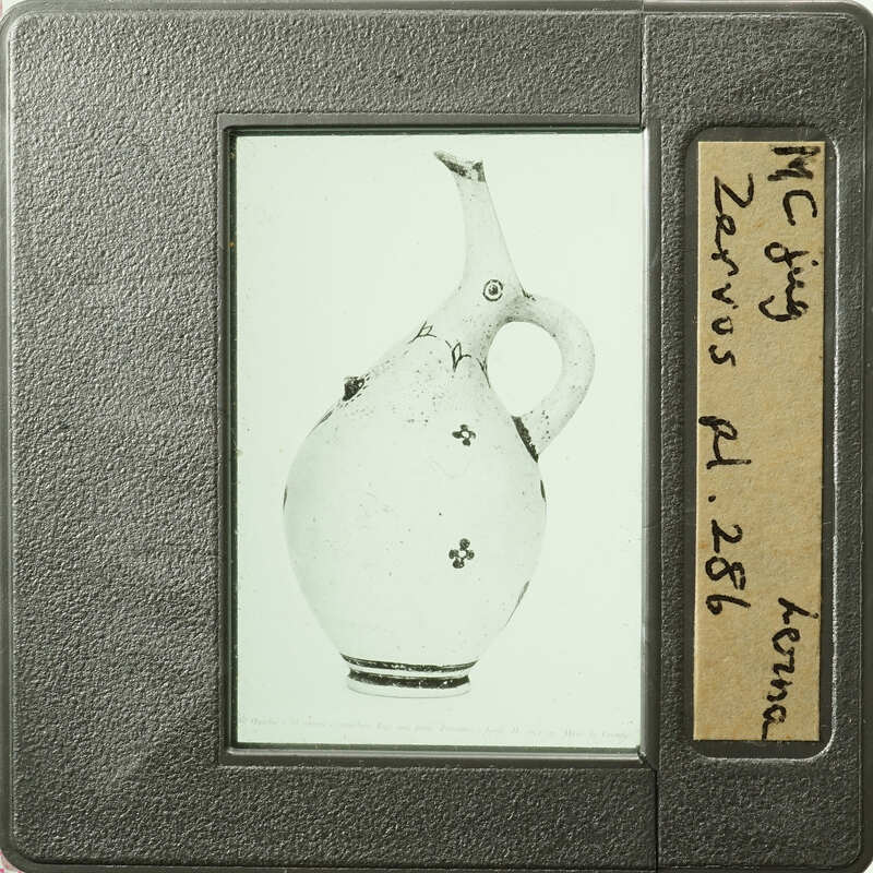 The image shows an antique vase with floral decorations.