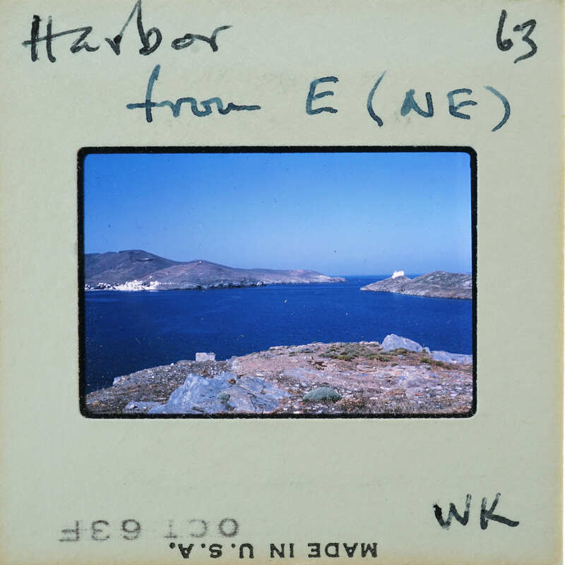 Picture of a harbor with mountains and water, on an old-fashioned film strip.