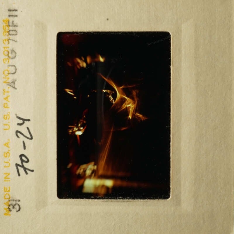 A black and white photo of a person with their back to the camera.