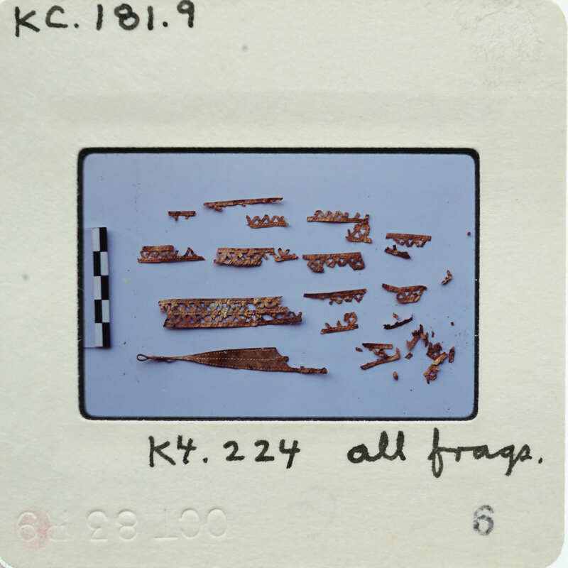 A collection of small, metallic parts displayed on a white surface.