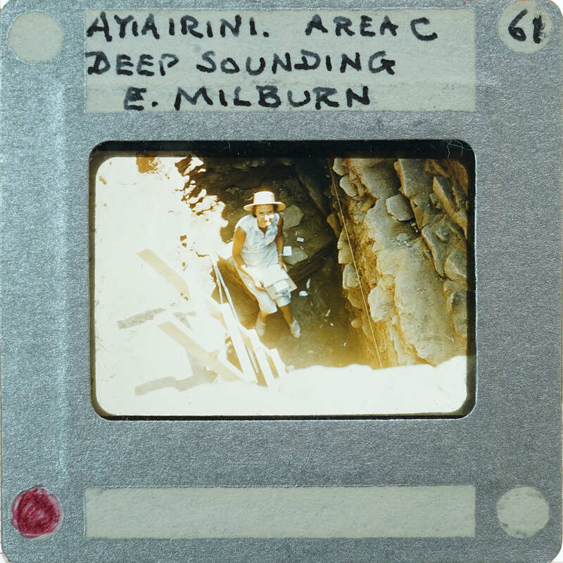 A vintage photo of a person in a cave with labels and numbers on the border.