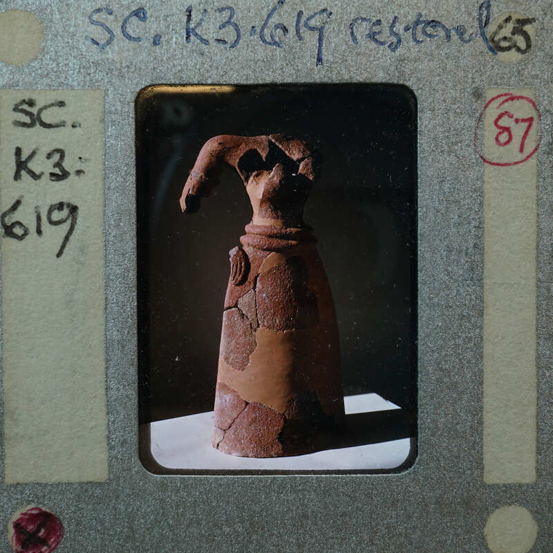 Terracotta headless figurine from 3/4 view front K3.619.
