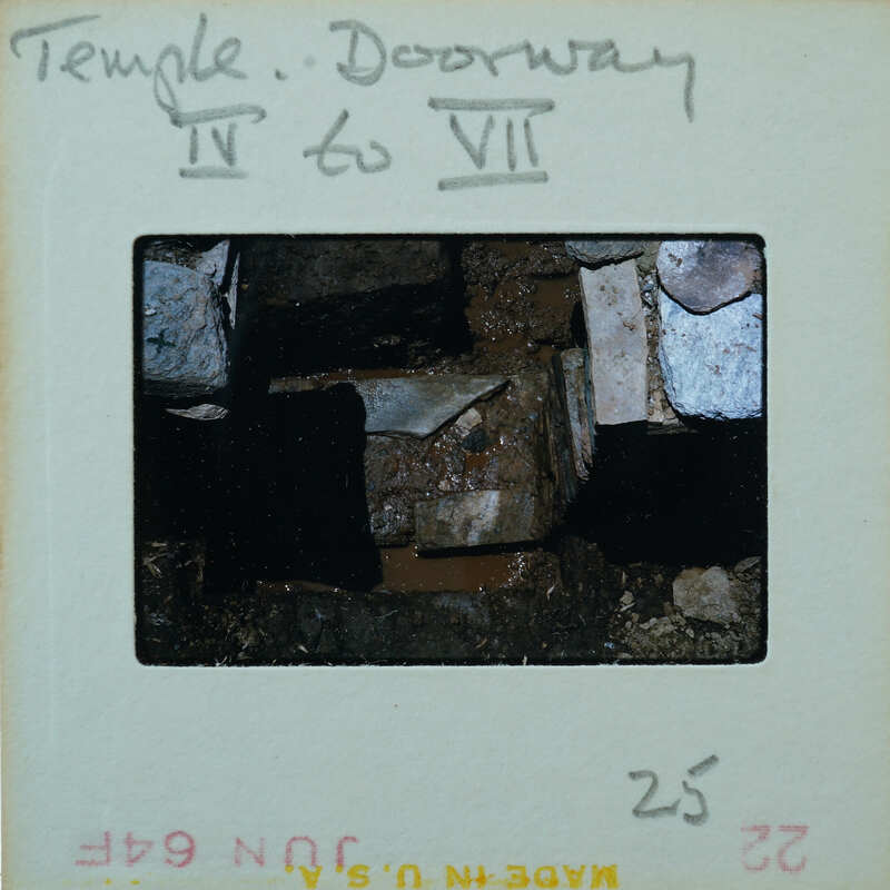 Marble step and doorway in muddy floor of building interior.
