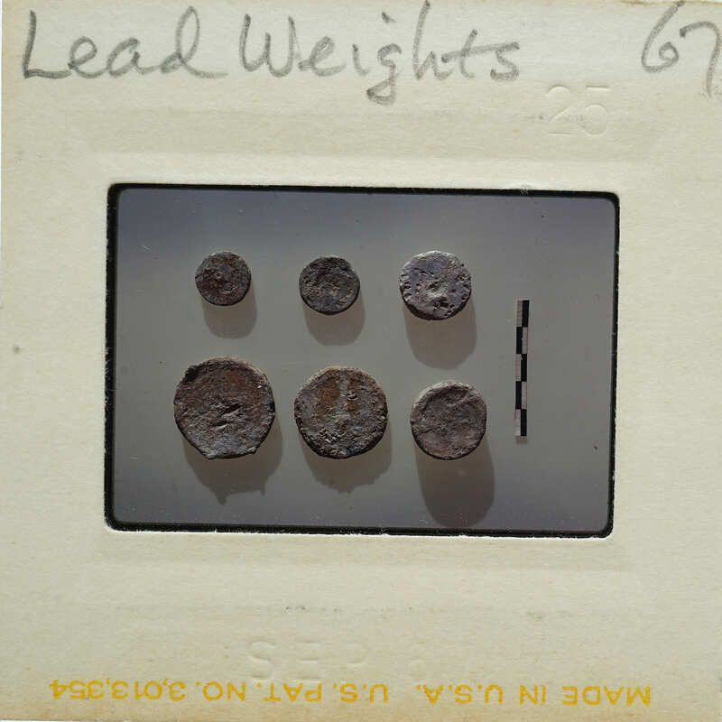 Image of circular lead weights on a surface.