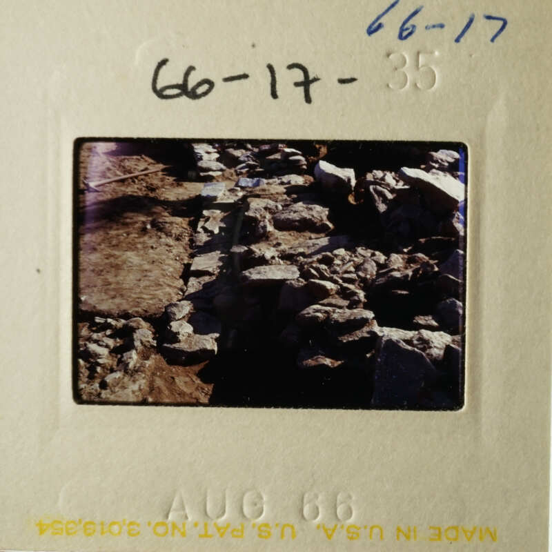 The photo shows an old, worn-out brick wall with some stones missing, possibly indicating age and weathering.