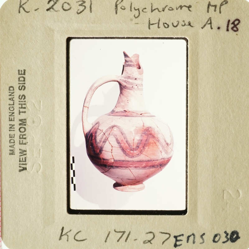 Ancient ceramic vase with red and orange stripes.