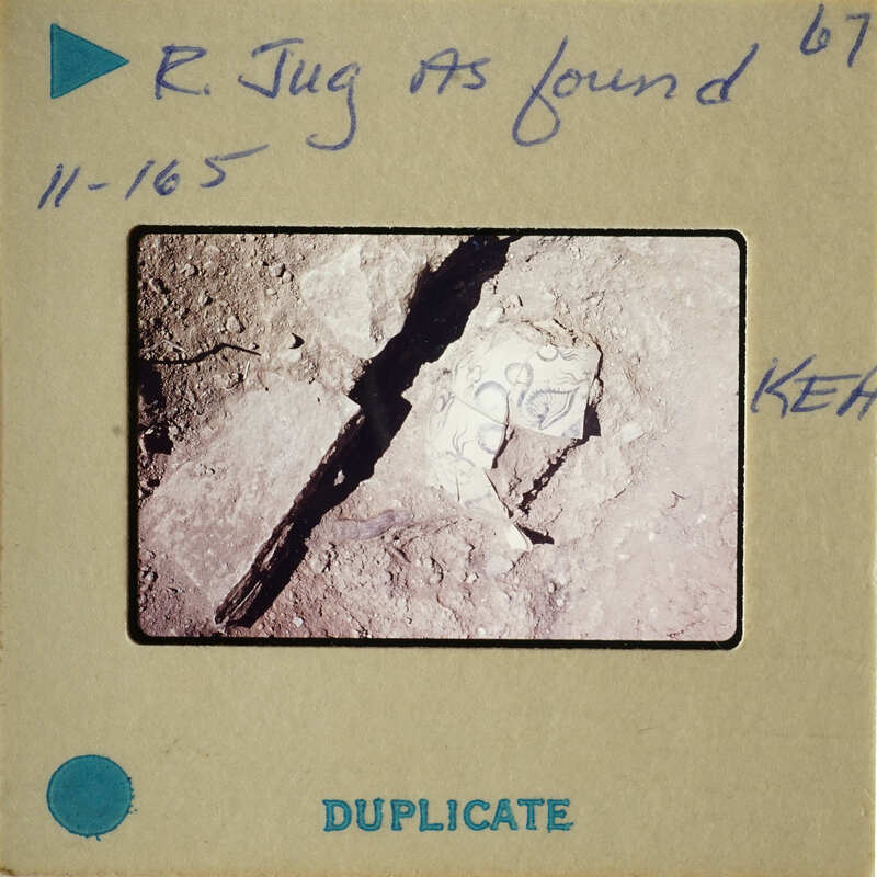 This is an image of a fossilized human skull found at a archaeological site, as indicated by the handwritten label on the film strip.