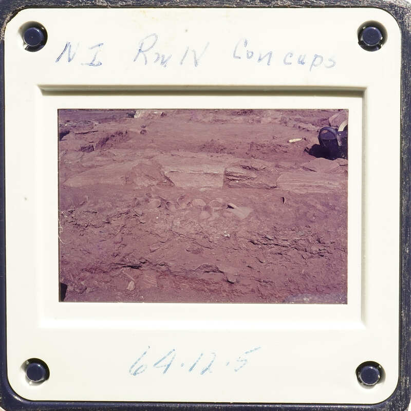 A photograph showing an excavation site with dirt and rocks, possibly part of an archaeological dig.