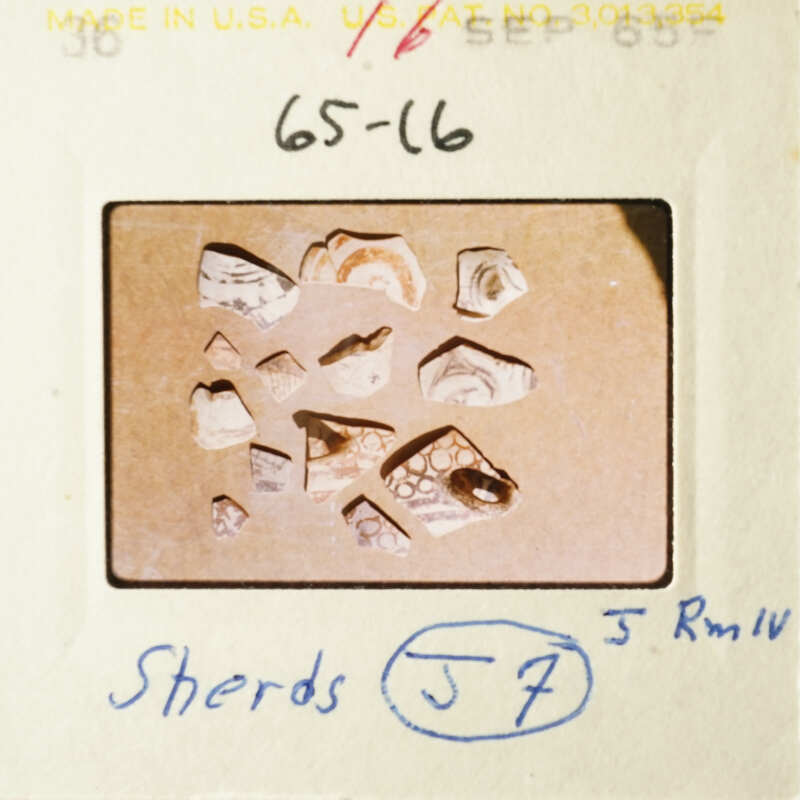 A collection of broken pottery pieces on a table.