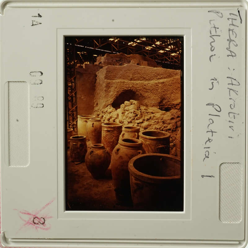 Old pottery displayed in an underground setting, possibly a storage area or museum exhibit.