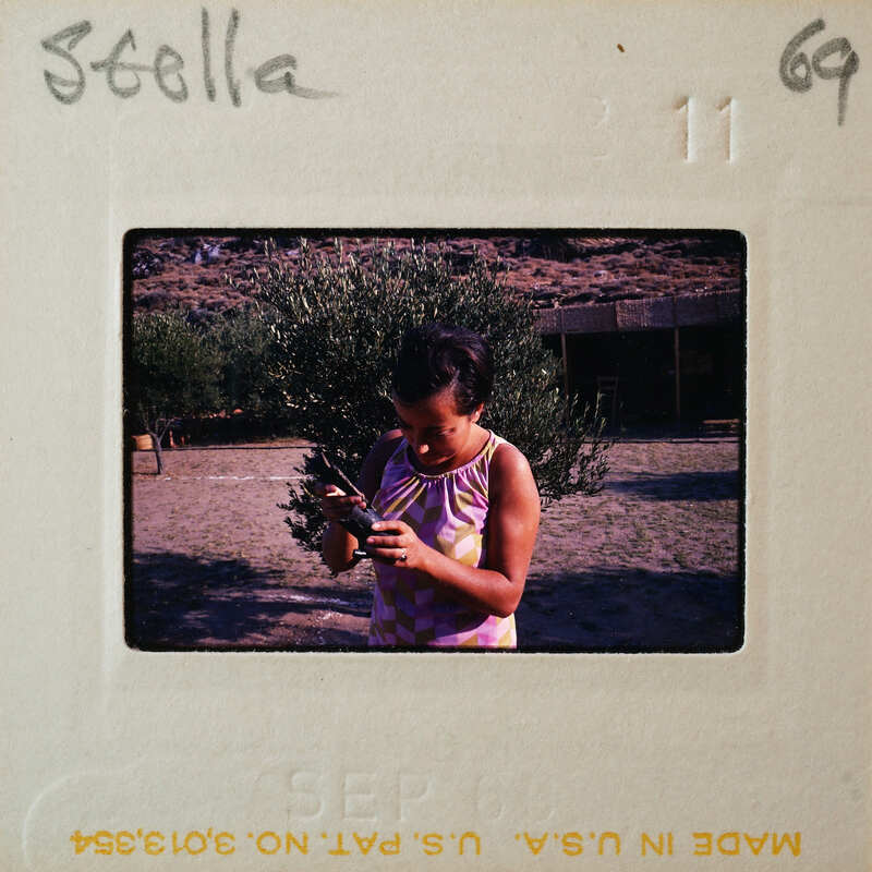 Woman looking at her cell phone while standing outside.