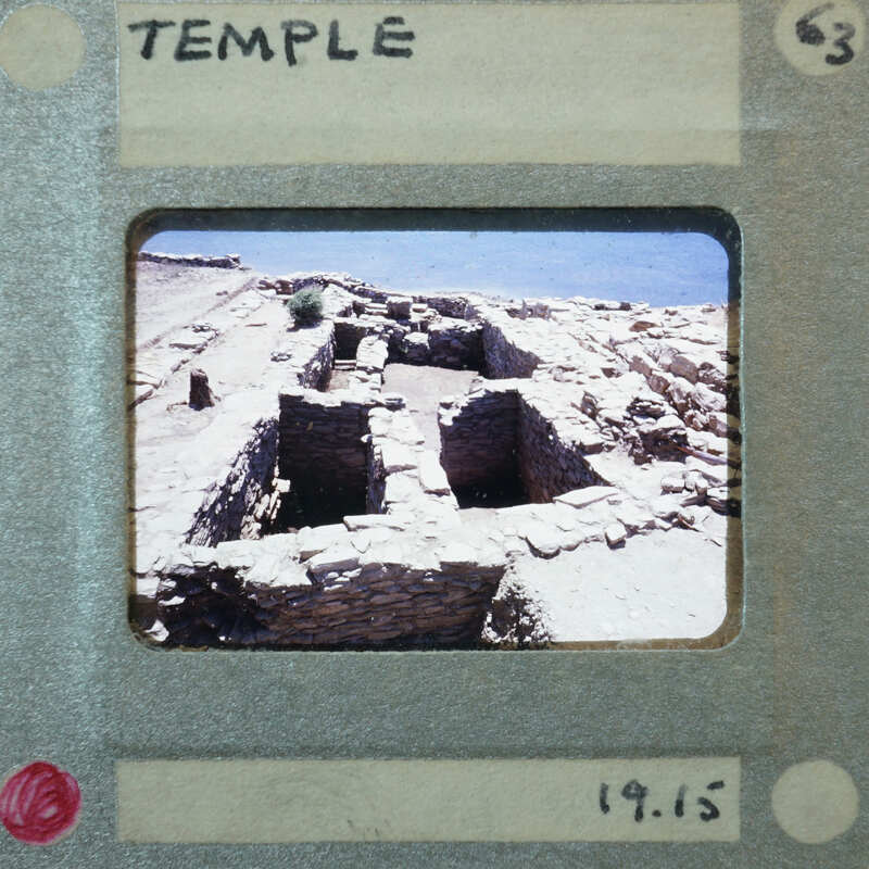 Walls of Temple and street on left, with water above.