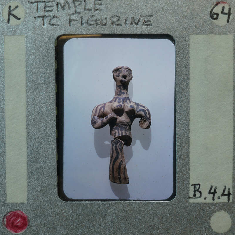 Partially restored human figurine with white clay and paint, broken on the bottom.