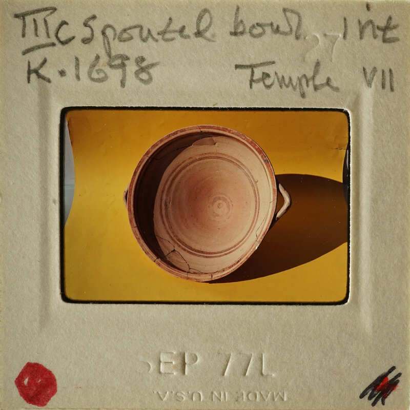 Ancient Greek vase on display with information label.