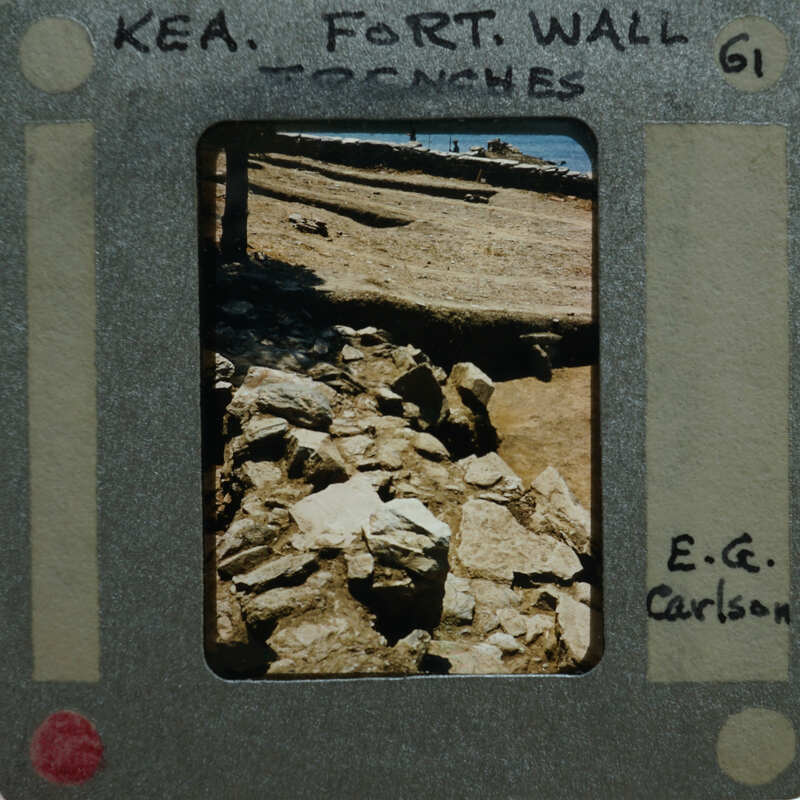 A photograph of a rock wall with film strip borders and information about the location and photographer.
