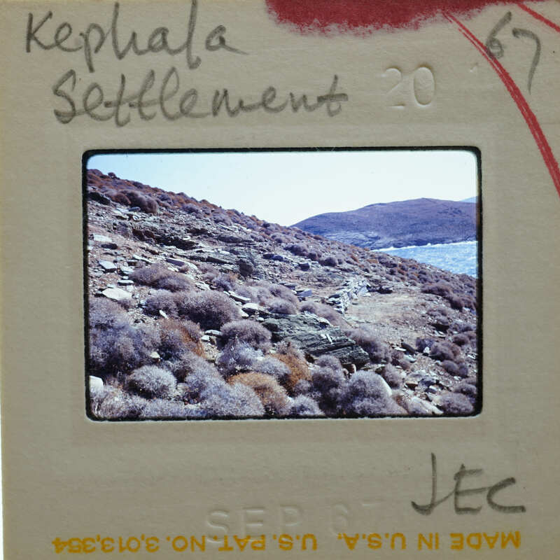 This is a photograph of a rocky coastline with a body of water, possibly an ocean or sea.