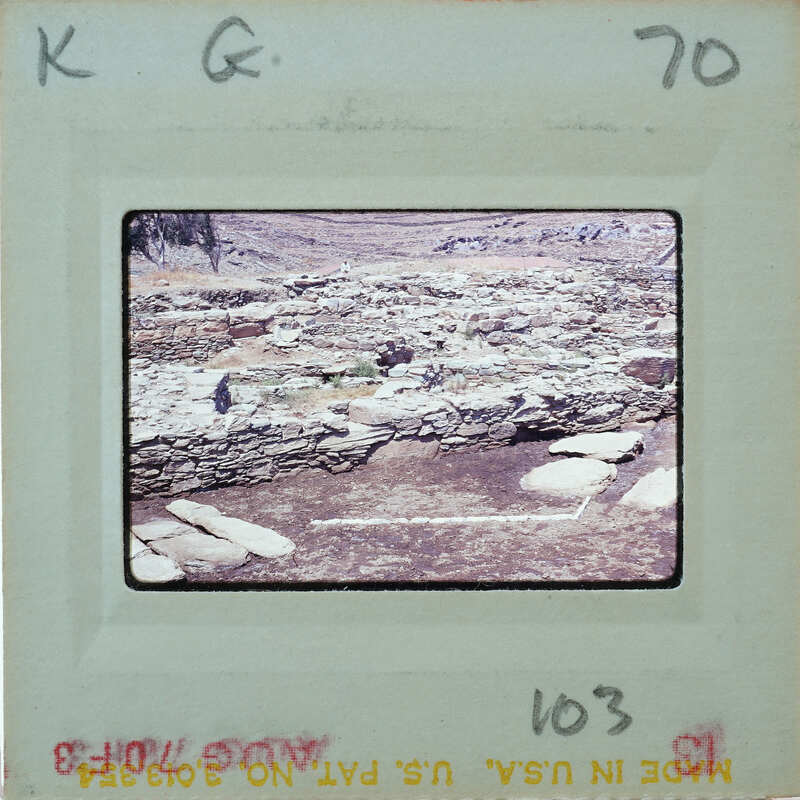 A photograph of a stone structure on a film strip.