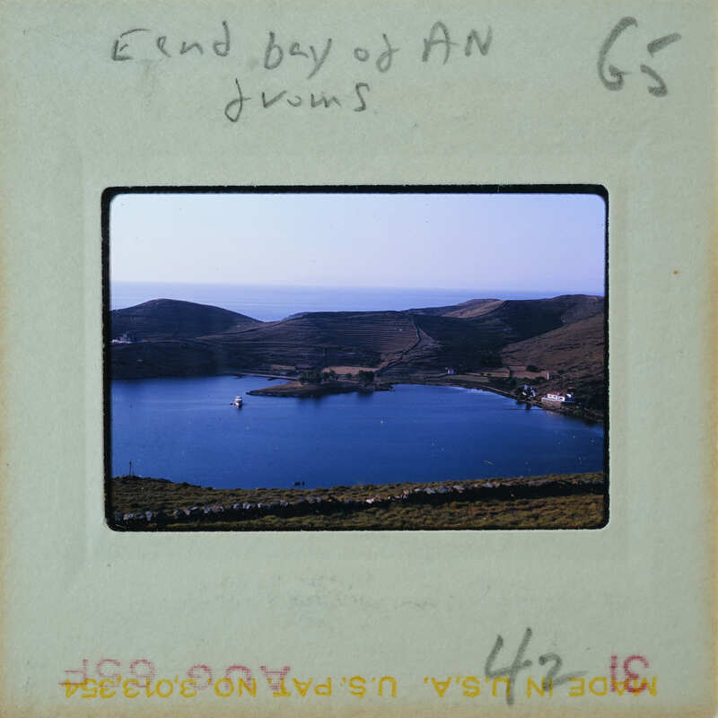 A vintage film strip with a scenic photograph of a body of water and hills, possibly from the 1950s or 60s.