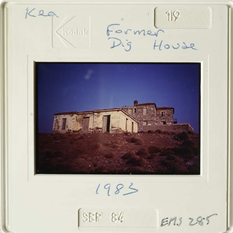 Old building with tiled roof on hillside.