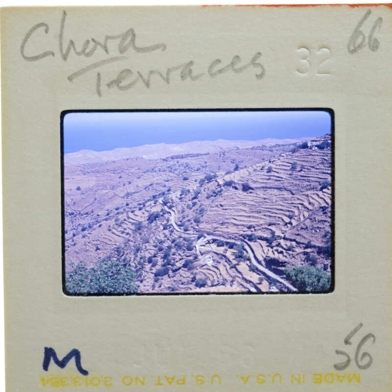 A slide of a terraced landscape with a watermark and handwritten notes on the border.