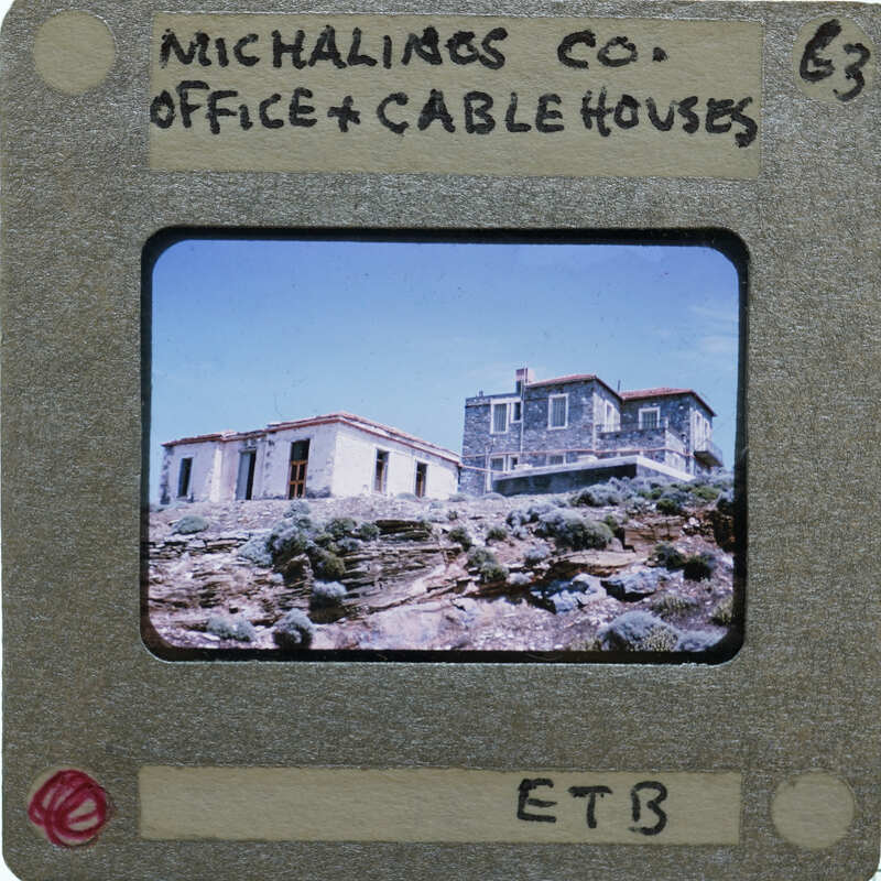 A slide of modern buildings on a stone hilltop.