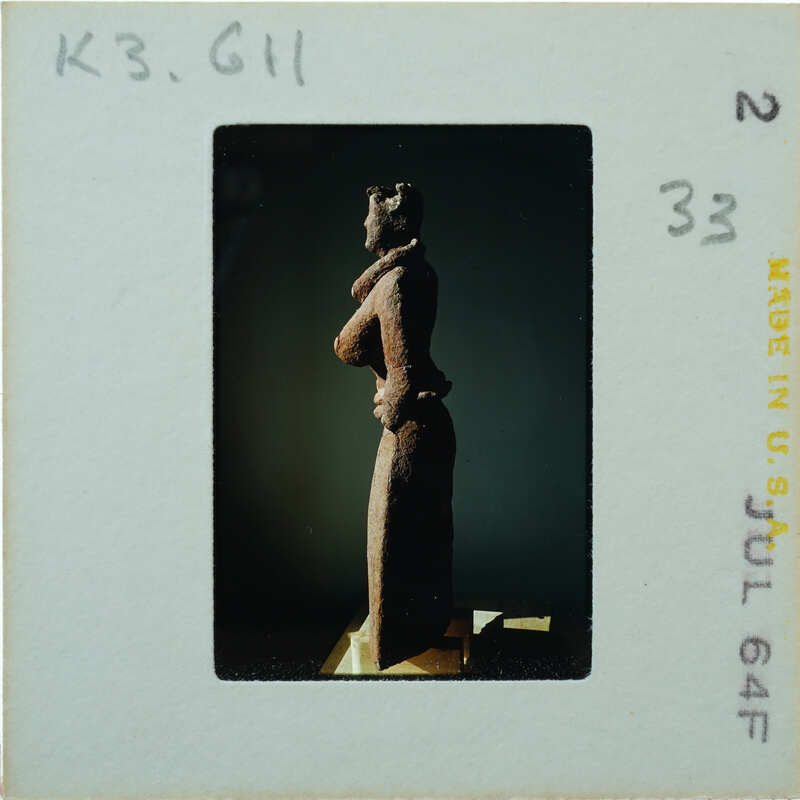 Detail of almost complete terracotta figurine from the side minus right arm.