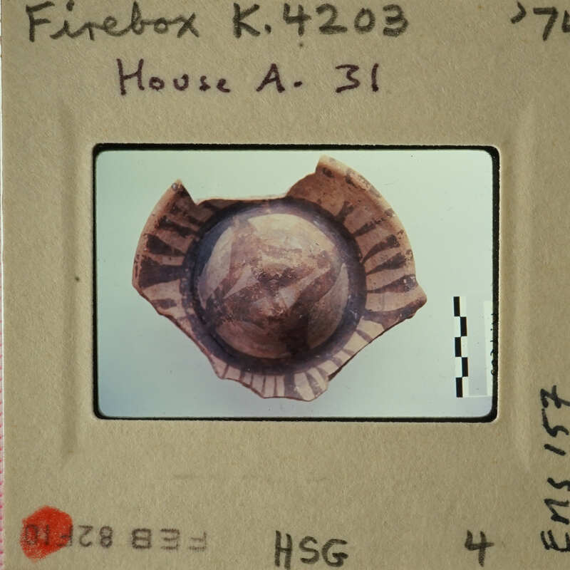 Old bullet on display with label reading "Firebox K-41203 House A-37".
