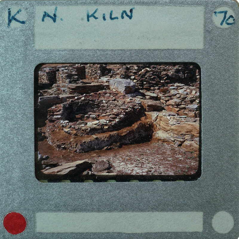 A photograph of a stone structure on film with a label and number.