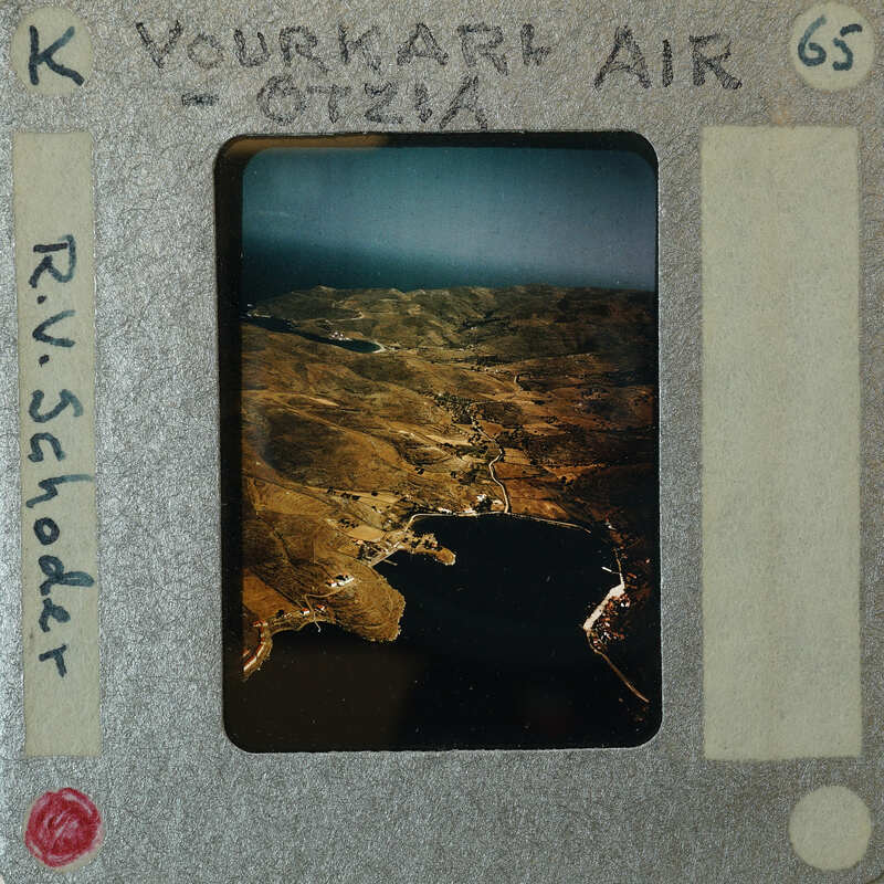 Aerial photograph of a mountainous landscape with a body of water.