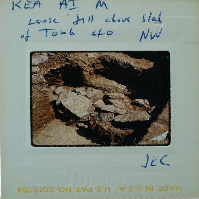 A photo of a cave entrance with handwritten notes on the back.
