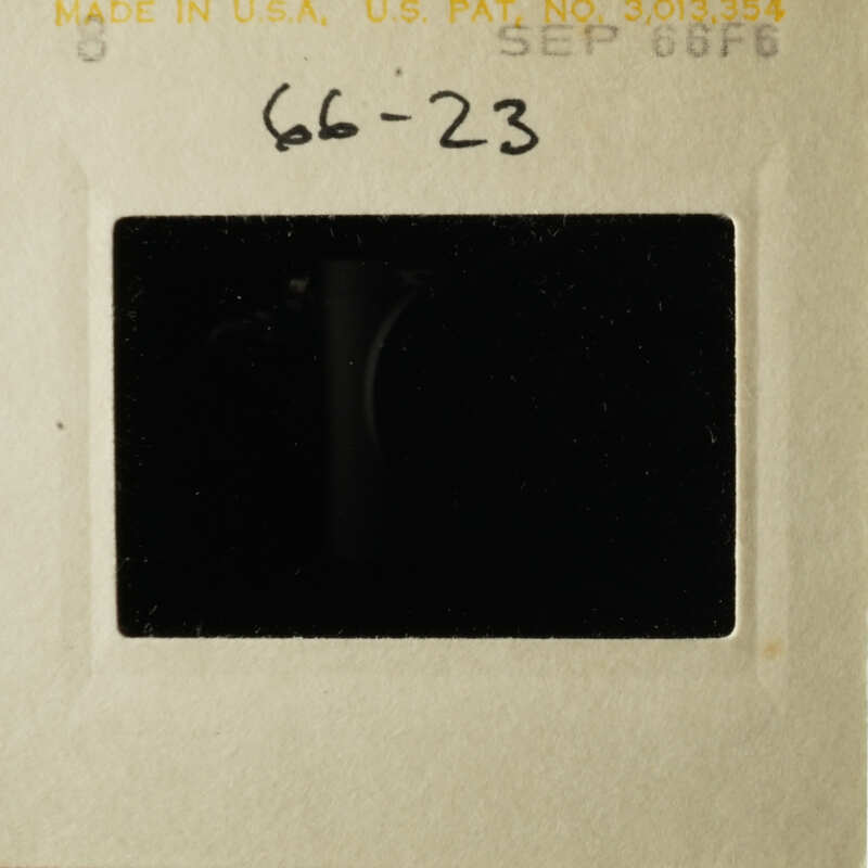 Black and white photo of an open film cartridge with a label on it.