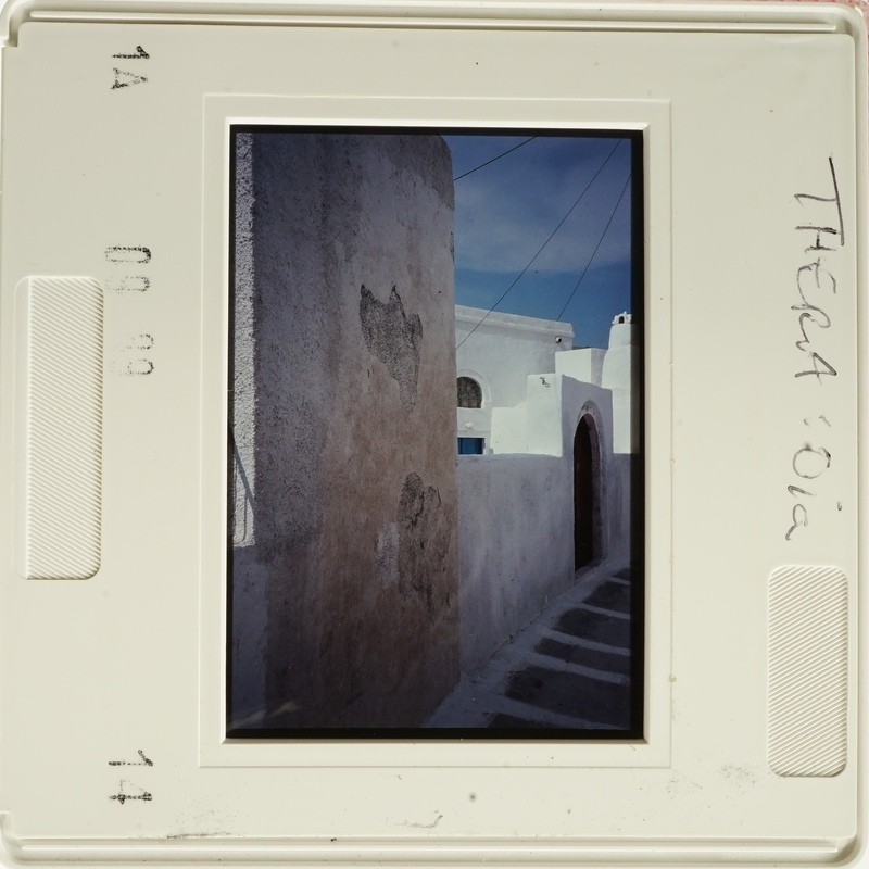 Old photograph with an upside-down view of a building and sky.