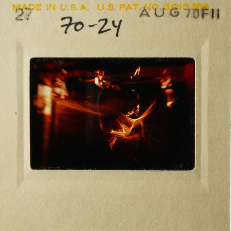 A vintage film strip with a blurry image of a candle flame.