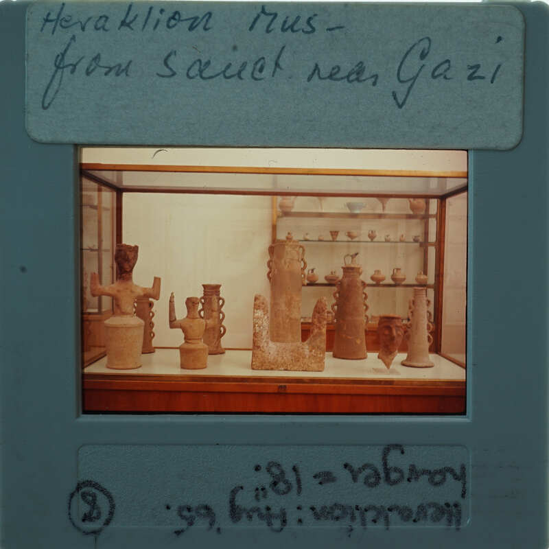 A photograph of a museum display case containing ancient pottery and artifacts.