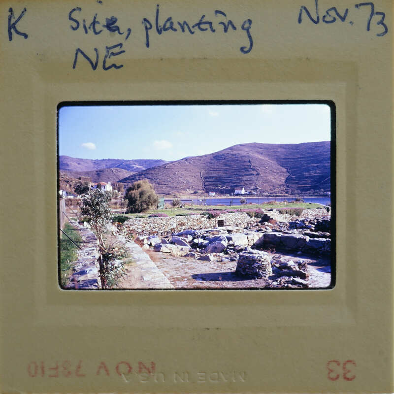 A photograph of a scenic landscape with mountains, water, and ruins, taken on November 7, 1973.