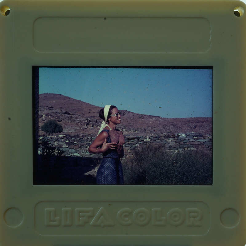 Picture of a woman in a village setting, with the Polaroid brand and "LIFE COLOR" label visible.