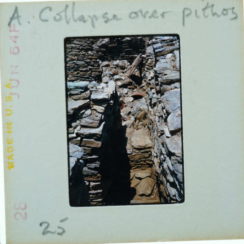 Old photo of a stone structure with collapsed parts, possibly ruins.