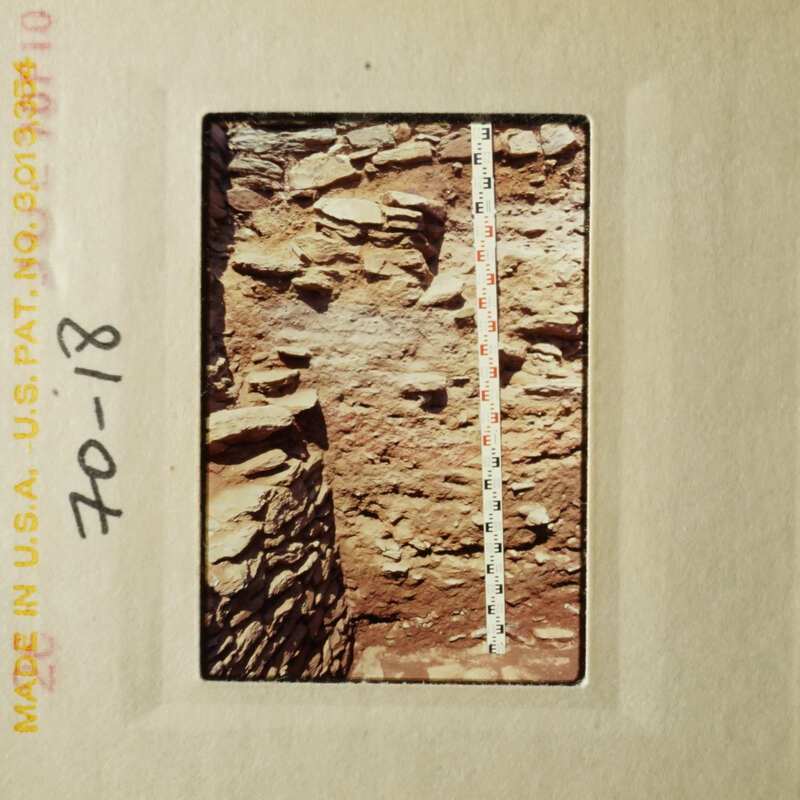 The photograph shows a rocky cliff face with a ruler indicating scale, taken on August 18, 2018.