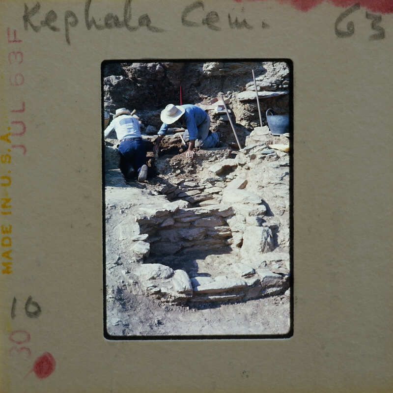 Two people working on excavating ancient ruins.