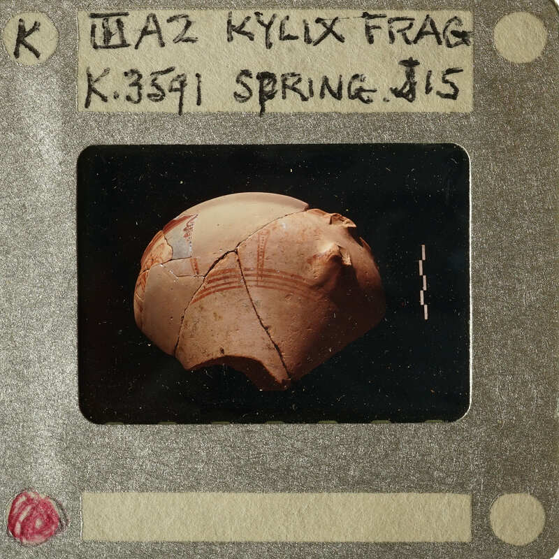 A photograph of an ancient pottery shard with markings on it.