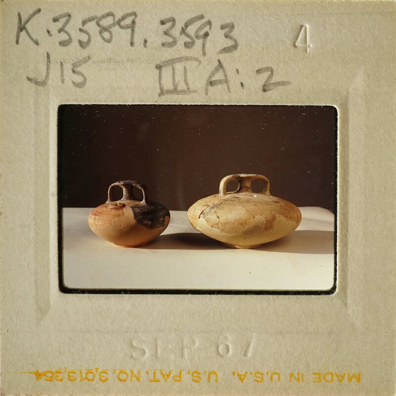 Two clay pots on display with an antique appearance.