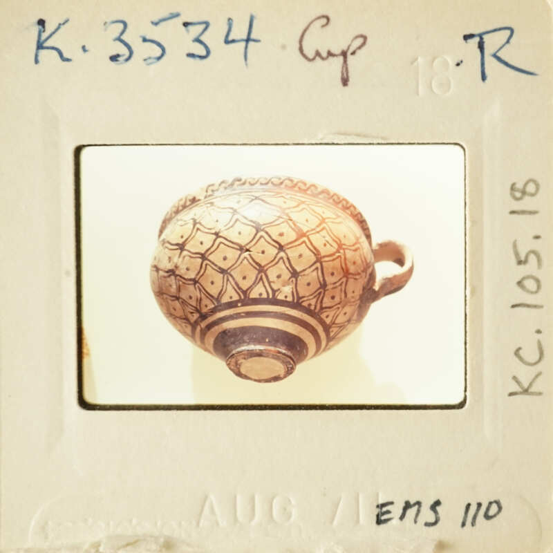 Ancient Greek vase with intricate designs and patterns, photographed on a white background.